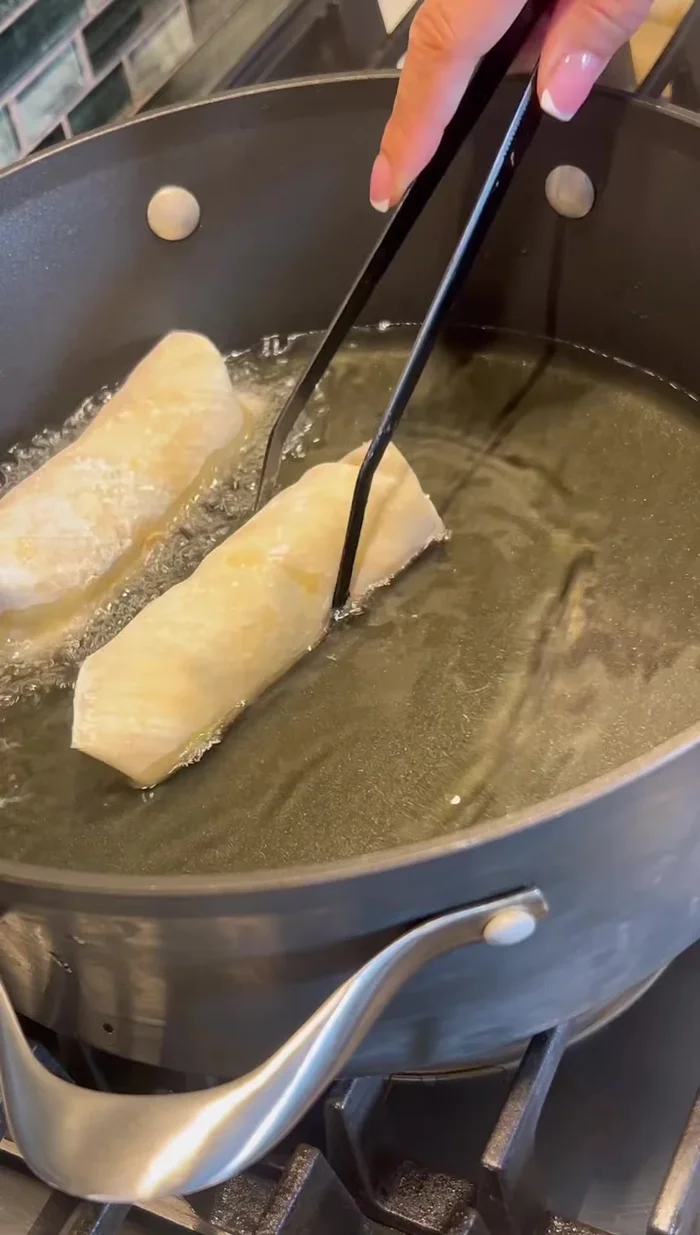 Heat oil in a deep skillet to 350°F (175°C).