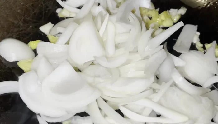 Add sliced onions and stir-fry.