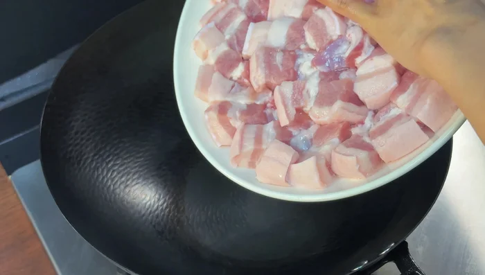 Cook the pork: Heat a pan (no oil needed), add the pork belly, and cook until the fat melts out. Save the rendered fat.