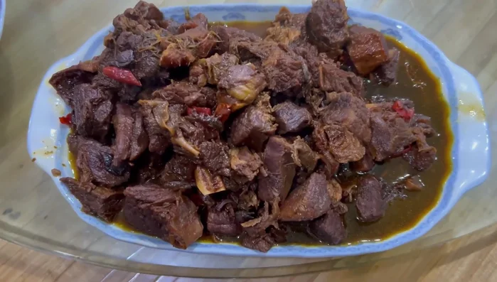 Assemble the Iftar spread: Arrange the cooked beef, stir-fried vegetables, soup, roti dish, rice, dates, cherry tomatoes, and omelette (718.48).