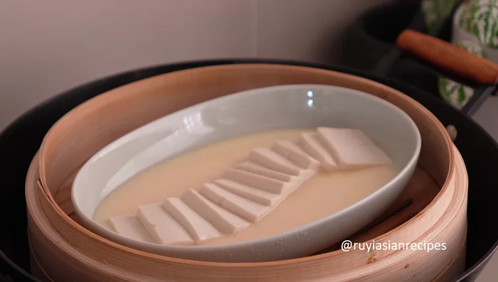 Check if cooked: The egg mixture should have turned pale yellow and be jiggly but not runny. Pour the sauce over the steamed tofu.