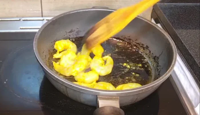 Heat white oil in a pan and fry prawns for 5-7 minutes on medium flame until slightly brown. Add salt.