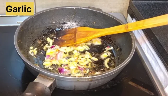 Add sliced onions to the pan and fry.