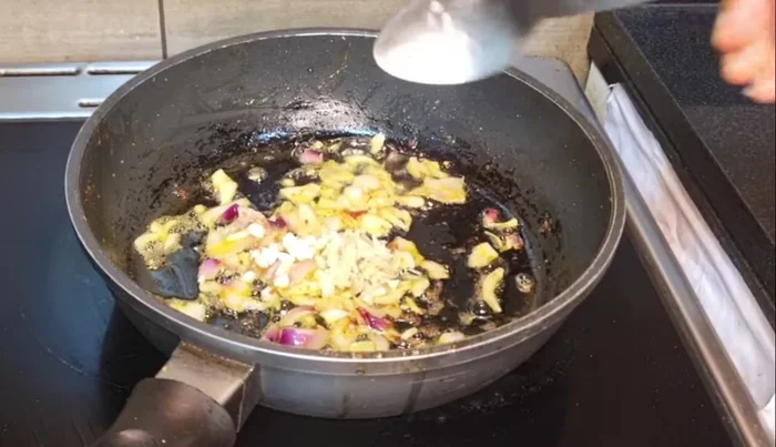 Add chopped garlic, ginger, and green chilies. Fry until slightly brown.