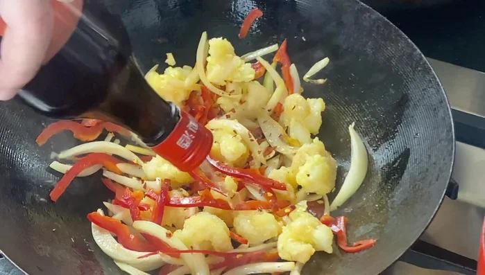 Toss to combine. Add chili flakes, Shaoxing wine, salt, and chili seasoning powder.