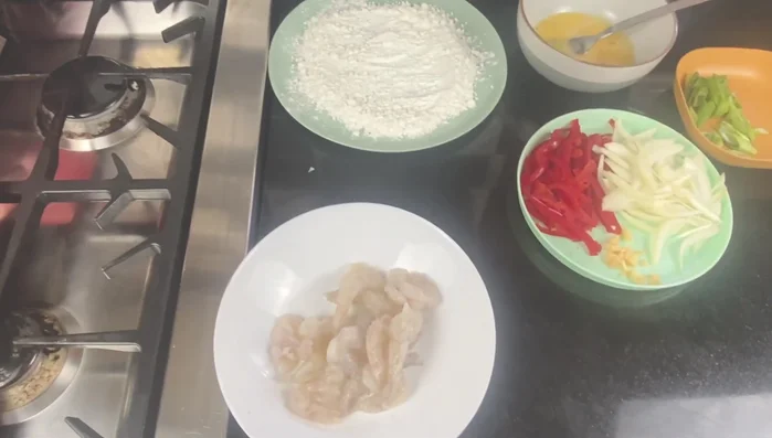 Place the prawns in a bowl and lightly coat with a tiny drizzle of egg.