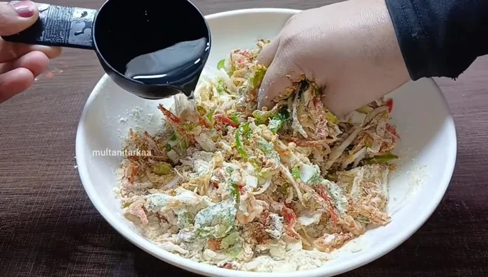 Add water and macaroni (for Macaroni Pakora): Gradually add water to the Chinese Pakora mixture to achieve a thick consistency. For Macaroni Pakora, add the boiled macaroni after mixing all other ingredients.