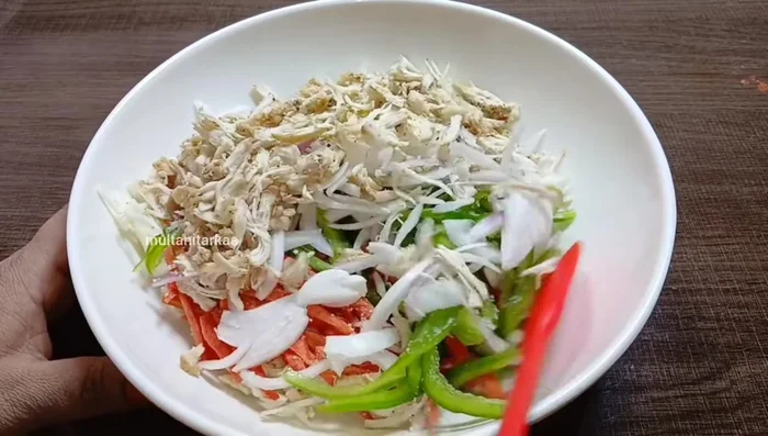 Combine ingredients: Mix the prepared vegetables, chicken (for Chinese Pakora), spices, sauces, and gram flour according to the respective recipes, leaving out water initially. Let it sit for 5-10 minutes to soften the vegetables.