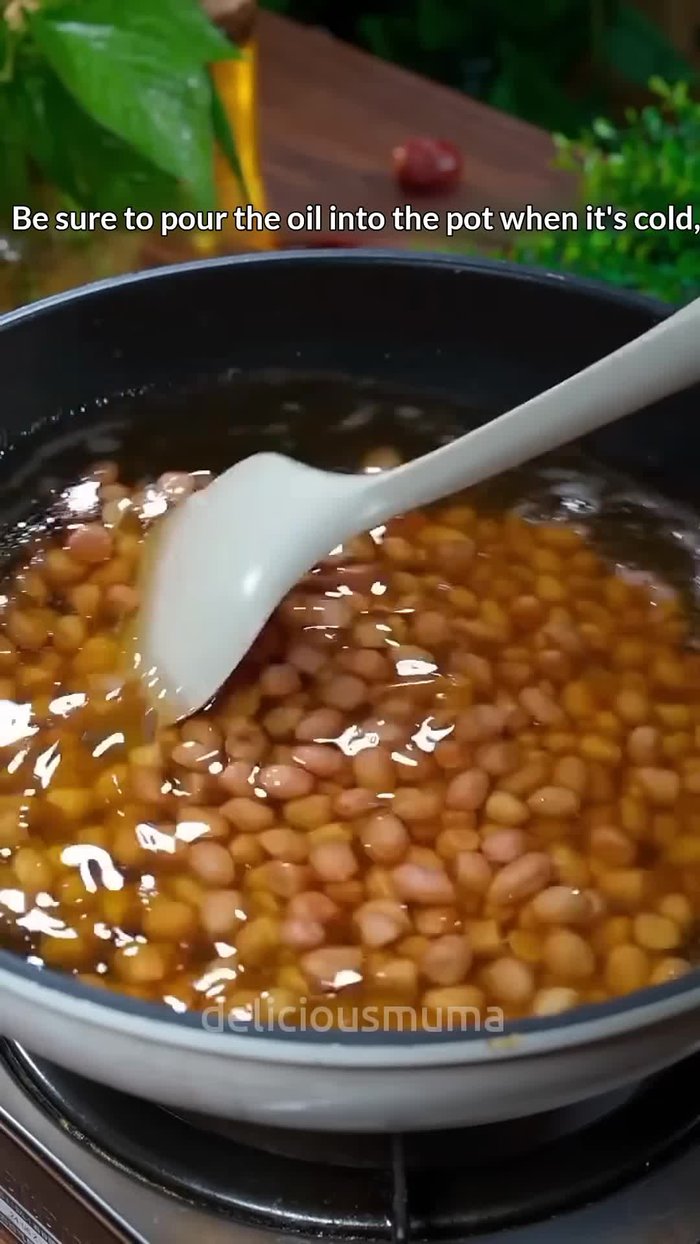 Pour oil into a cold pot and heat gradually. Fry peanuts until slightly red. Remove and set aside.