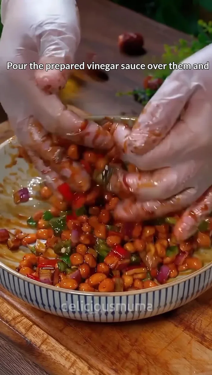 Pour the prepared vinegar sauce over the peanuts and vegetables. Toss everything together to coat evenly.