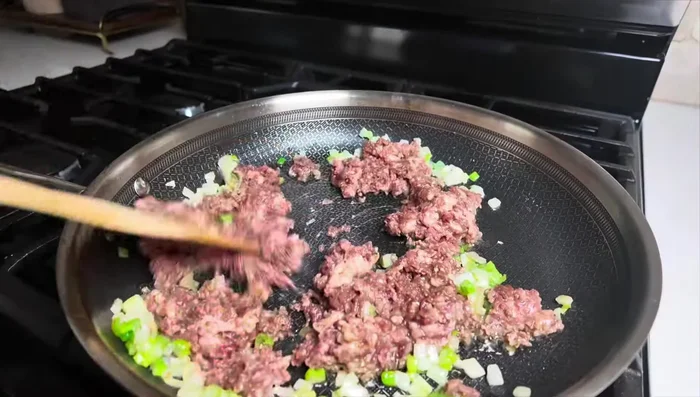 Add marinated ground beef and cook until almost done. Add chopped garlic and stir to prevent burning.