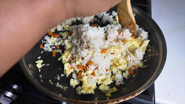 Mix eggs, rice, and carrots together. Add soy sauce and hoisin sauce, mix well.