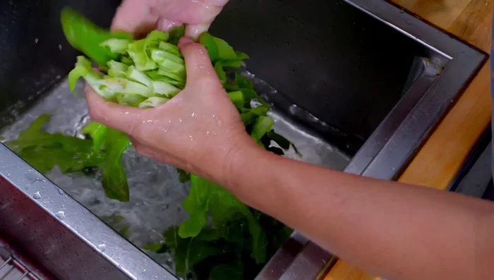 Wash and tear Chinese lettuce in half.