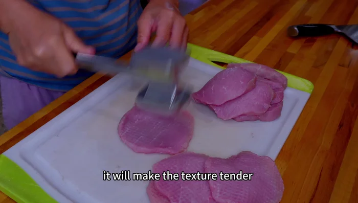 Tenderize the pork using a meat tenderizer's rough side. This makes the meat tender, improves flavor absorption, and helps the starch coating adhere during frying.
