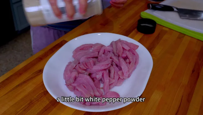 Season the pork with salt, white pepper, and egg. The egg helps the starch coat better.