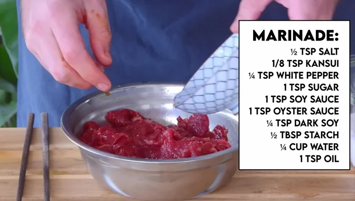 Prepare beef: Marinate thinly sliced beef. Add 1/4 cup water and coat with oil. (207.519)