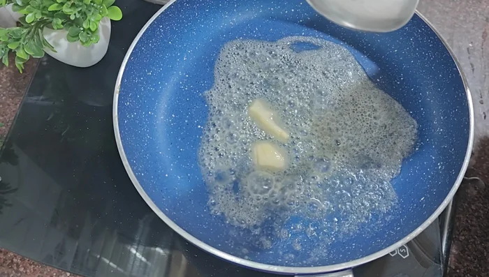 In a pan, melt butter. Add chopped garlic.