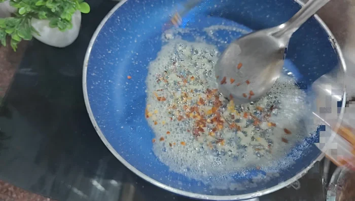 Add chilli flakes (adjust to your spice preference).