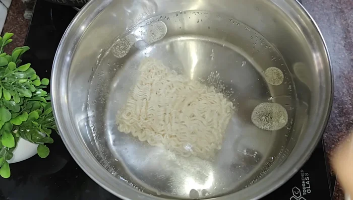 Boil Maggi noodles 90% (do not overcook).