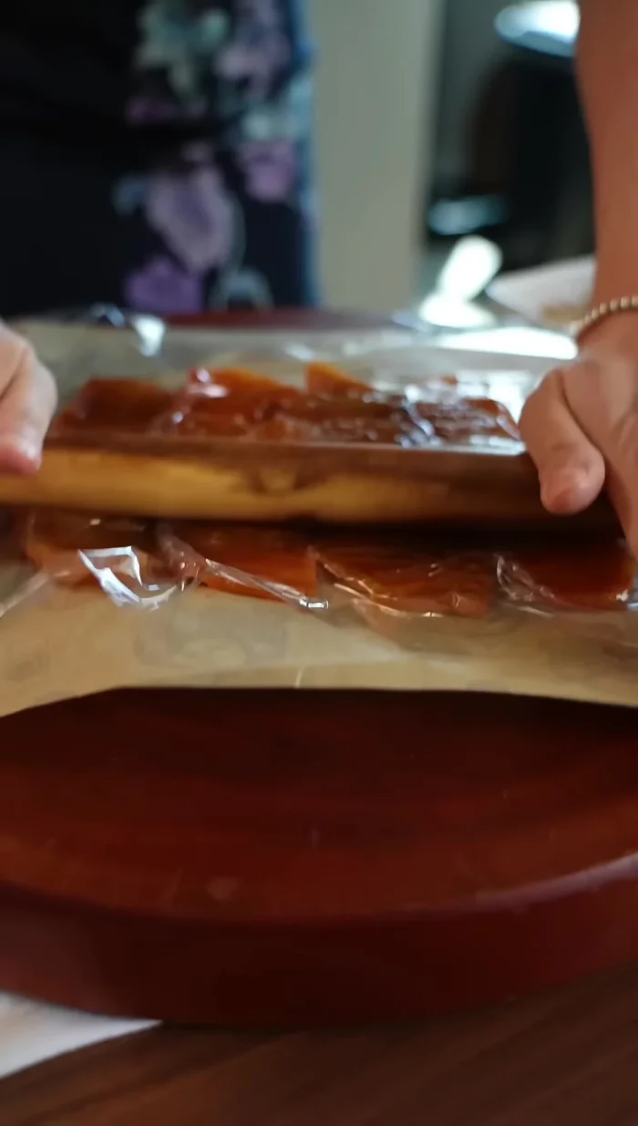 Remove the plastic wrap. Spread cream cheese evenly on half of the flattened persimmon, similar to spreading peanut butter.