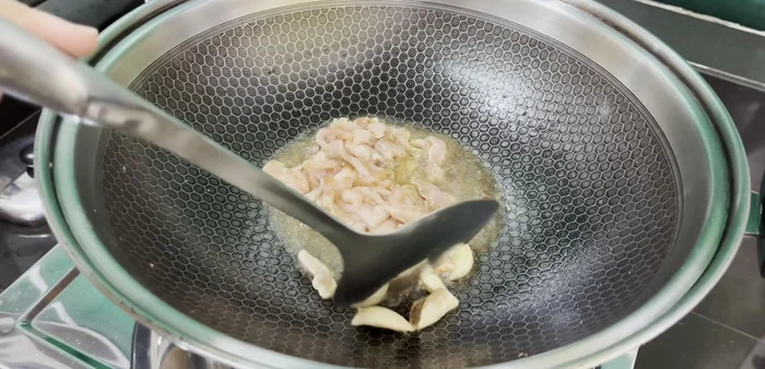 Add pork loin strips and stir-fry until lightly browned.