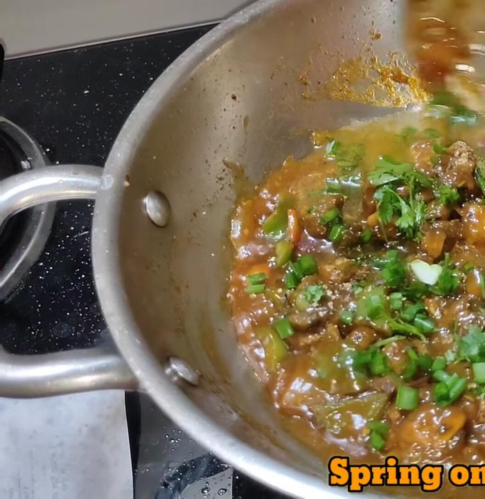 Add black pepper powder, coriander leaves, and spring onions. Mix and serve.