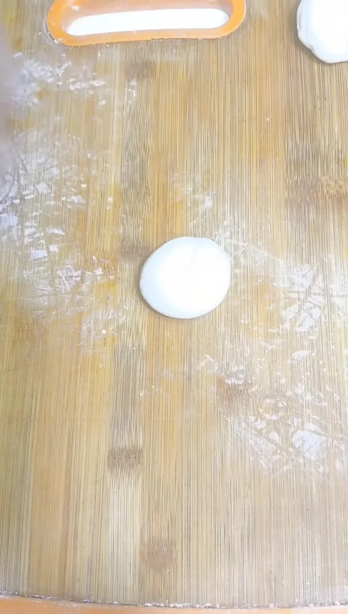Make the spring roll sheets: Divide the rested dough into small portions. Roll each portion into a thin circle (puri size). Stack 2-3 rolled dough circles, oiling and flouring between each layer. Roll again. Cook on a lightly heated pan until lightly browned on both sides.
