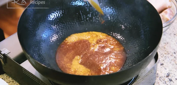 Return the pork to the wok. Add Chinese cooking wine and stir to evaporate the alcohol.