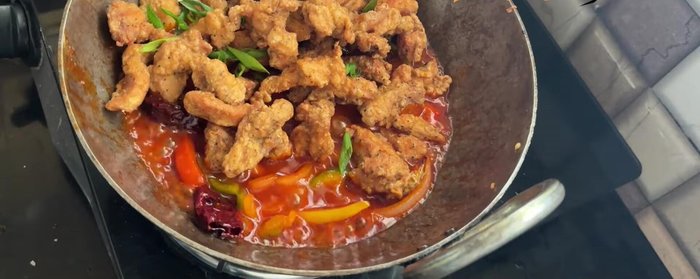 Add fried chicken and spring onion greens. Toss for 1-2 minutes until well coated.