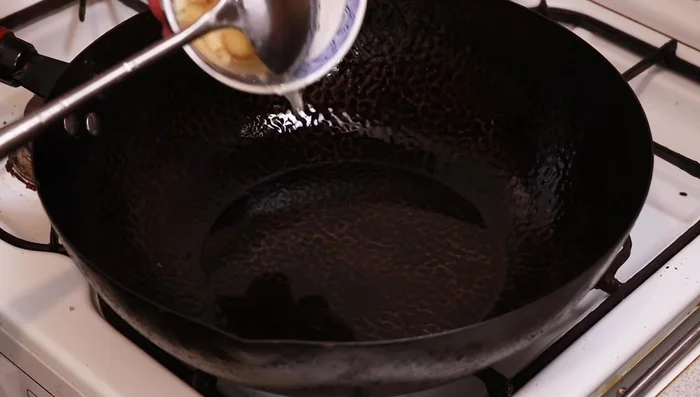 Add the garlic and ginger to the hot wok. Be careful as it may spit due to the water.