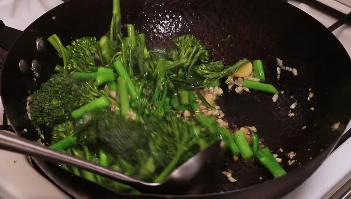 Add the broccoli heads and stir-fry.