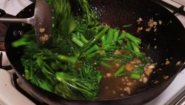 Add chicken stock and wine. Stir.