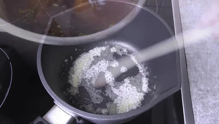Sauté garlic in a little oil, then deglaze with the sauce mixture. Bring to a boil briefly.
