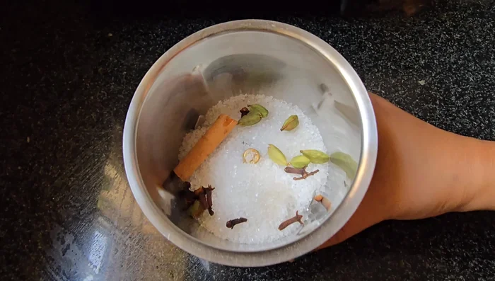 Make fried rice powder: Blend sugar, cinnamon, cloves, and cardamom into a fine powder.