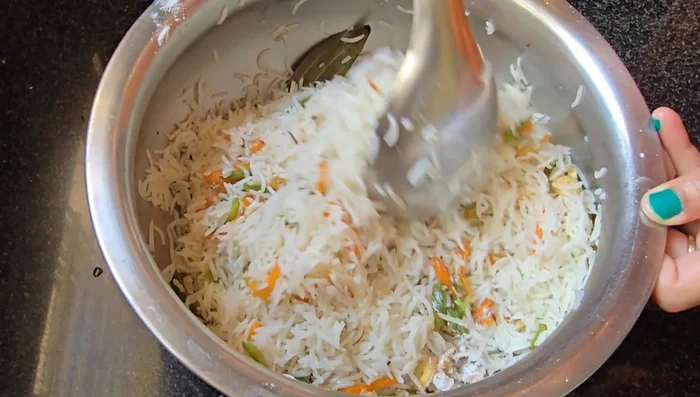 Finish fried rice: Mix all layers well and let it simmer on the stove for 2 minutes to allow flavors to meld.
