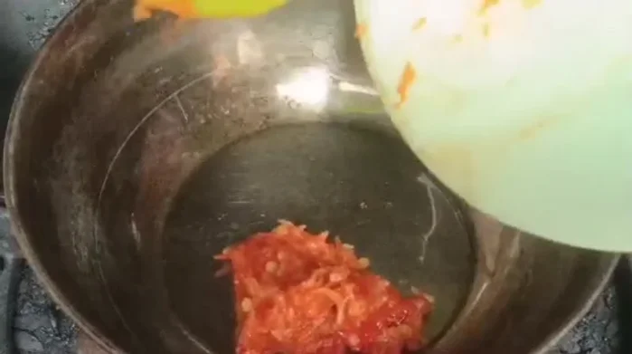 Cook the pureed chilies with salt, chicken stock powder, flavoring, sugar, pepper, and orange juice until boiling.