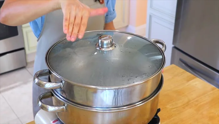 Steam shrimp in a large steamer over high heat until pink and cooked through (about 2 minutes).