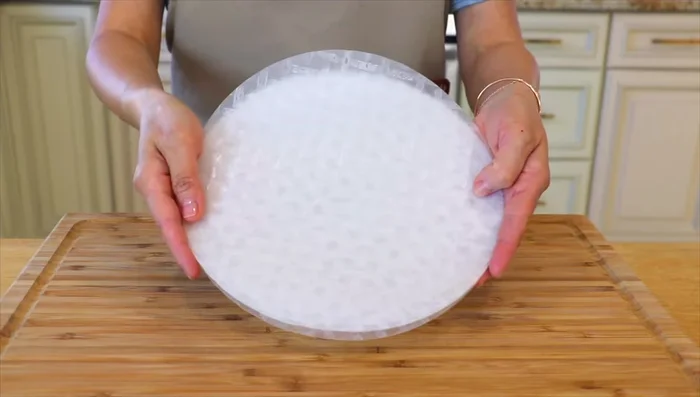 Stack rice paper, cut in half, and dip each piece in water for 1-2 seconds to soften.