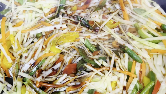 Add light soy sauce, red chilli sauce, Schezwan sauce, and salt. Sauté for 1-2 minutes.