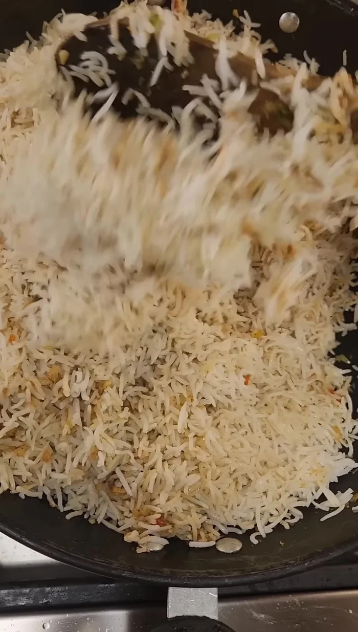Add cold cooked basmati rice and mix well until the garlic flavor is distributed.