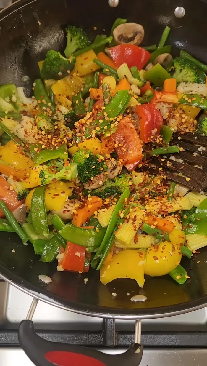 Add capsicums, sauté well, then add crushed red chilies and mix.