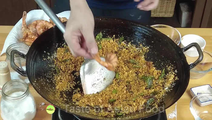 Combine and serve: Return the fried shrimp to the wok. Mix with the breadcrumb mixture until the crispy ingredients adhere to the shrimp. Serve immediately.