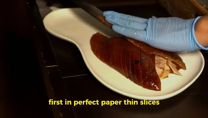 Carefully carve the skin in paper-thin slices, then slice the meat separately. Serve with mandarin pancakes, scallion slivers, cucumber matchsticks, and hoisin sauce. (490)