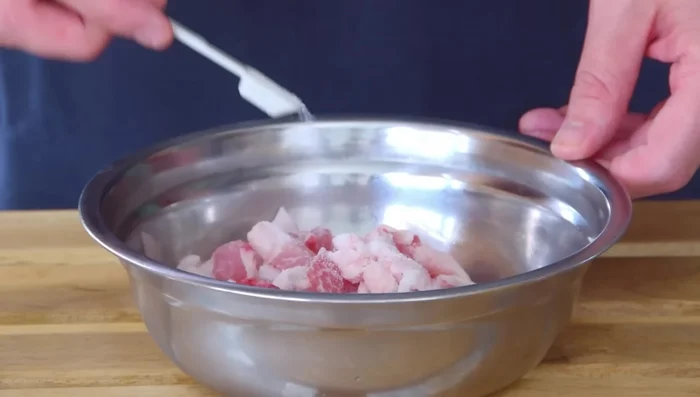 Coat pork with 2 tablespoons of oil and add to a cool wok or pot. Over medium flame, slowly fry and render out the lard (about 20 minutes). Stir and flip periodically.