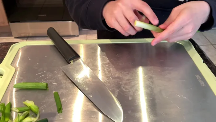 Chop green onions, cutting at a 30° angle.