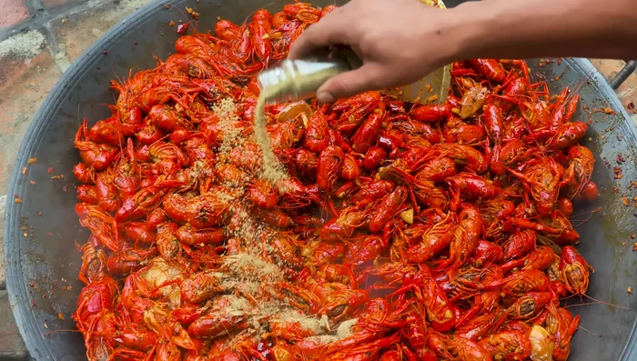 Add more chili peppers and salt to the pan, adjusting seasoning as needed.