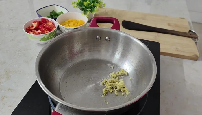 Heat oil, add grated ginger and garlic, cook until golden brown.