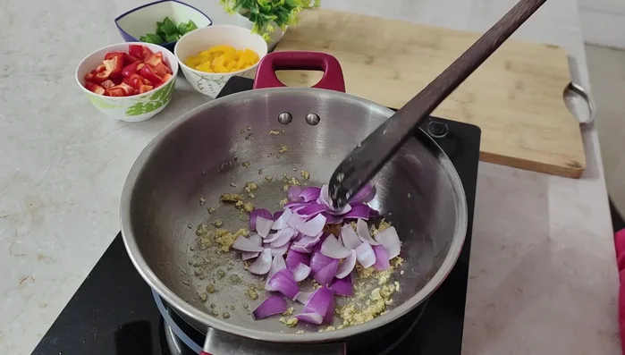Add chopped onions and sauté on high flame for a minute.