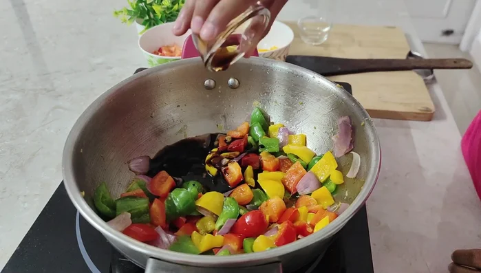 Add vinegar, soya sauce, and tomato chili sauce.