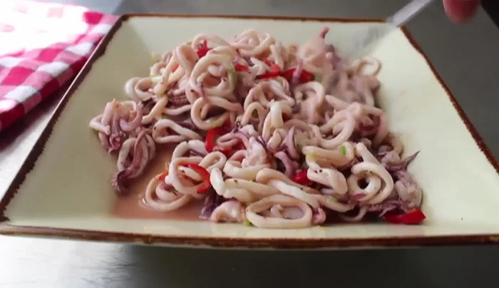 Cool and drain: Let the cooked squid cool to room temperature. Toss gently with a fork to help cool and separate. (277.08)